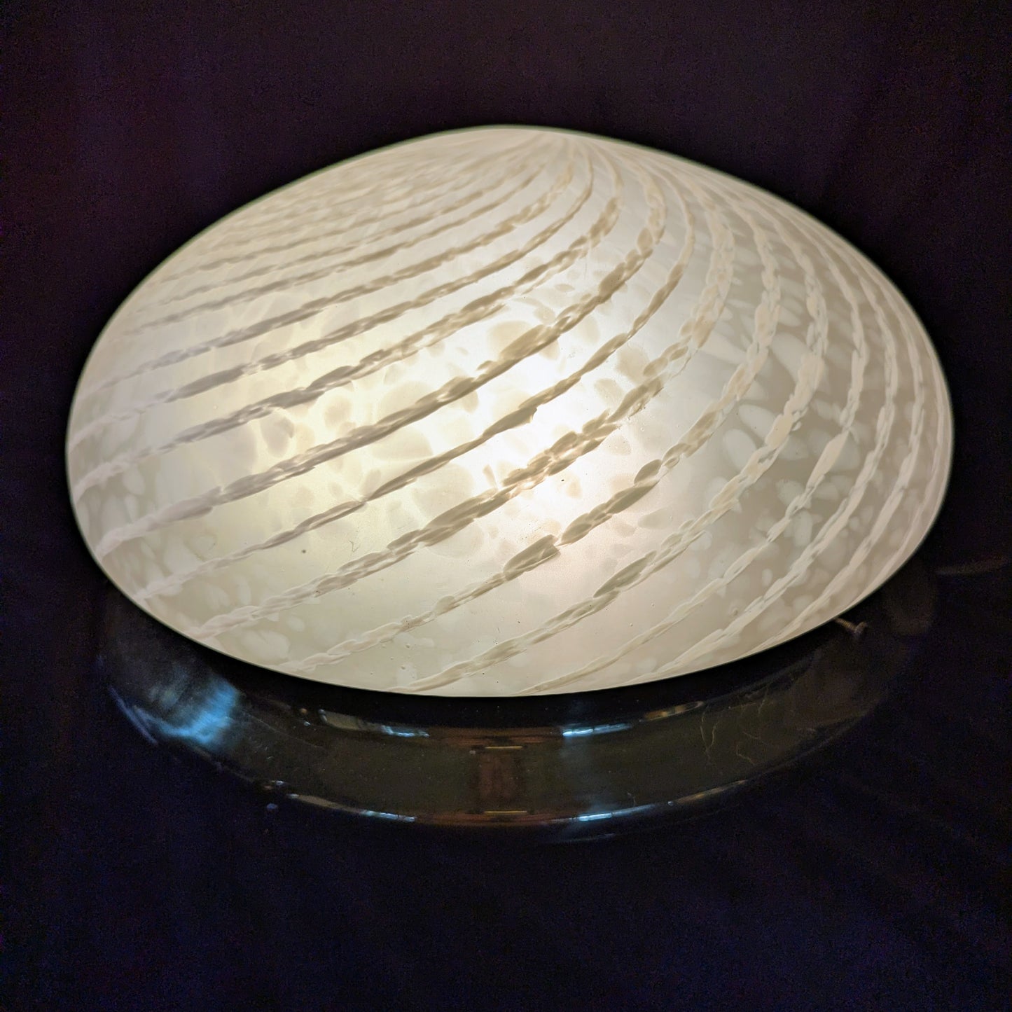 An Italian white Murano glass Domed Ceiling Light With Brass Gallery on a black bacgkround