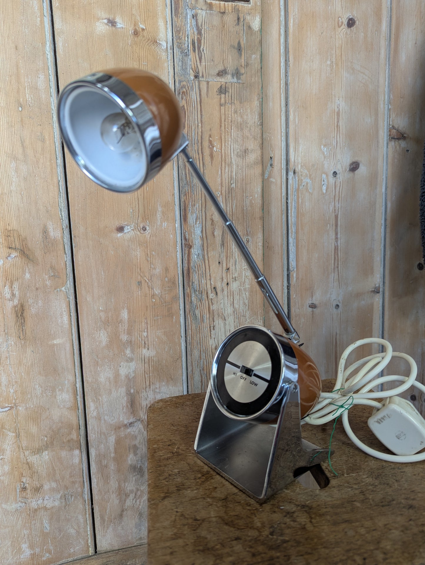 a brown Hamilton Industries Model 60 1957 Desk Lamp on a wooden background