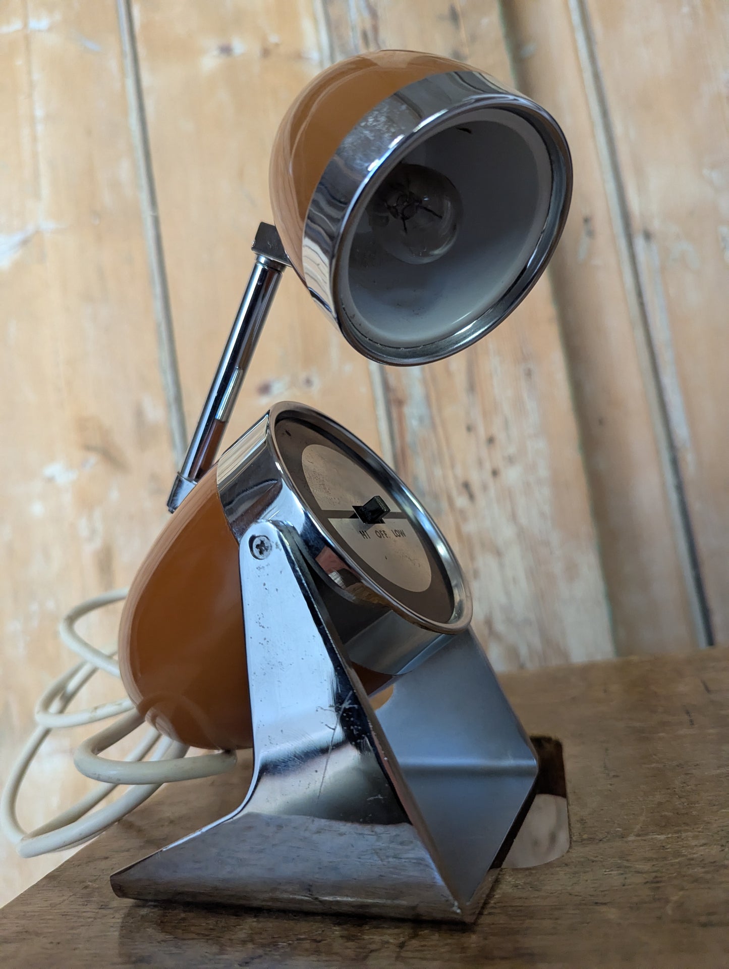 a brown Hamilton Industries Model 60 1957 Desk Lamp on a wooden background