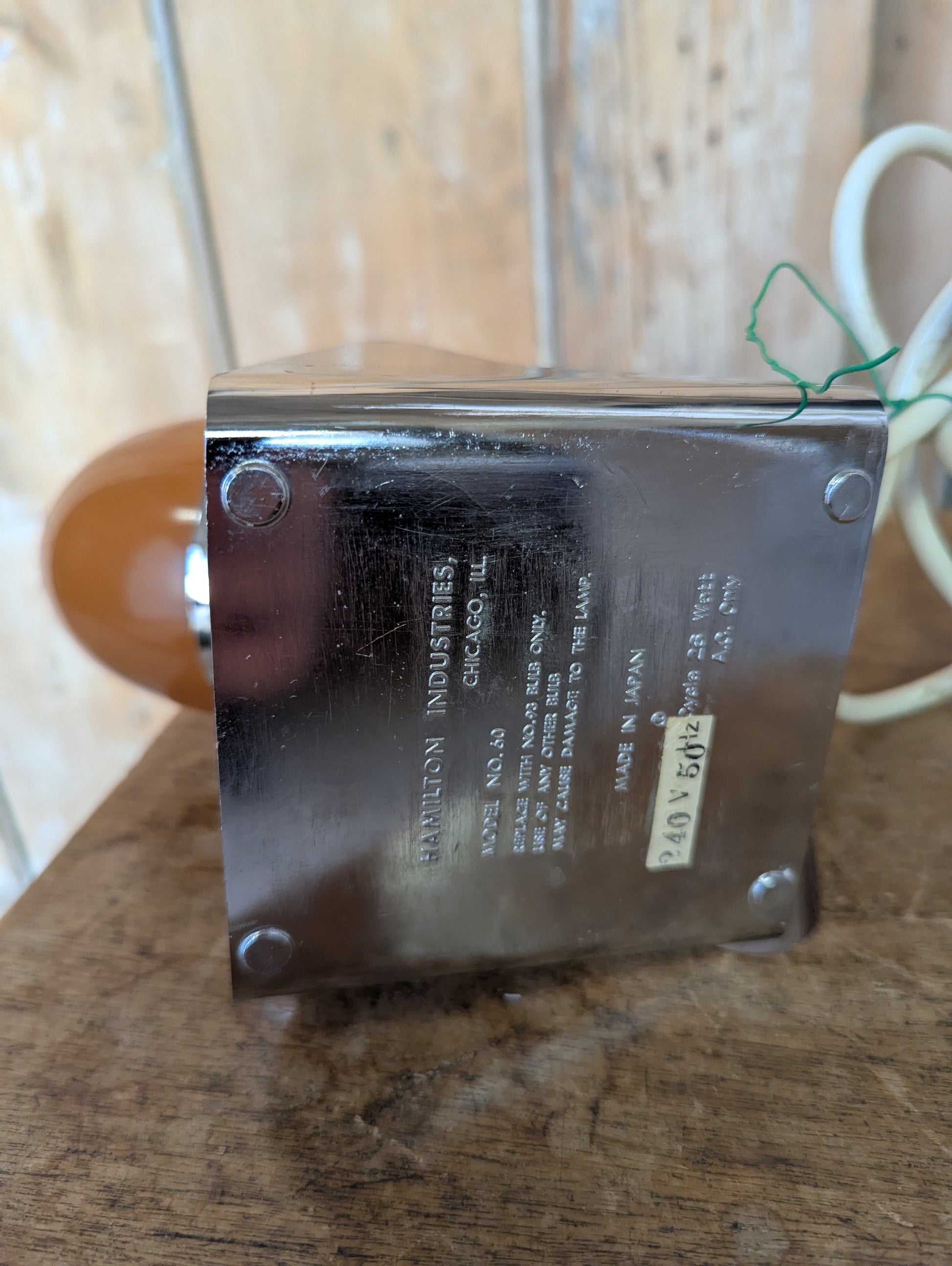 a brown Hamilton Industries Model 60 1957 Desk Lamp on a wooden background