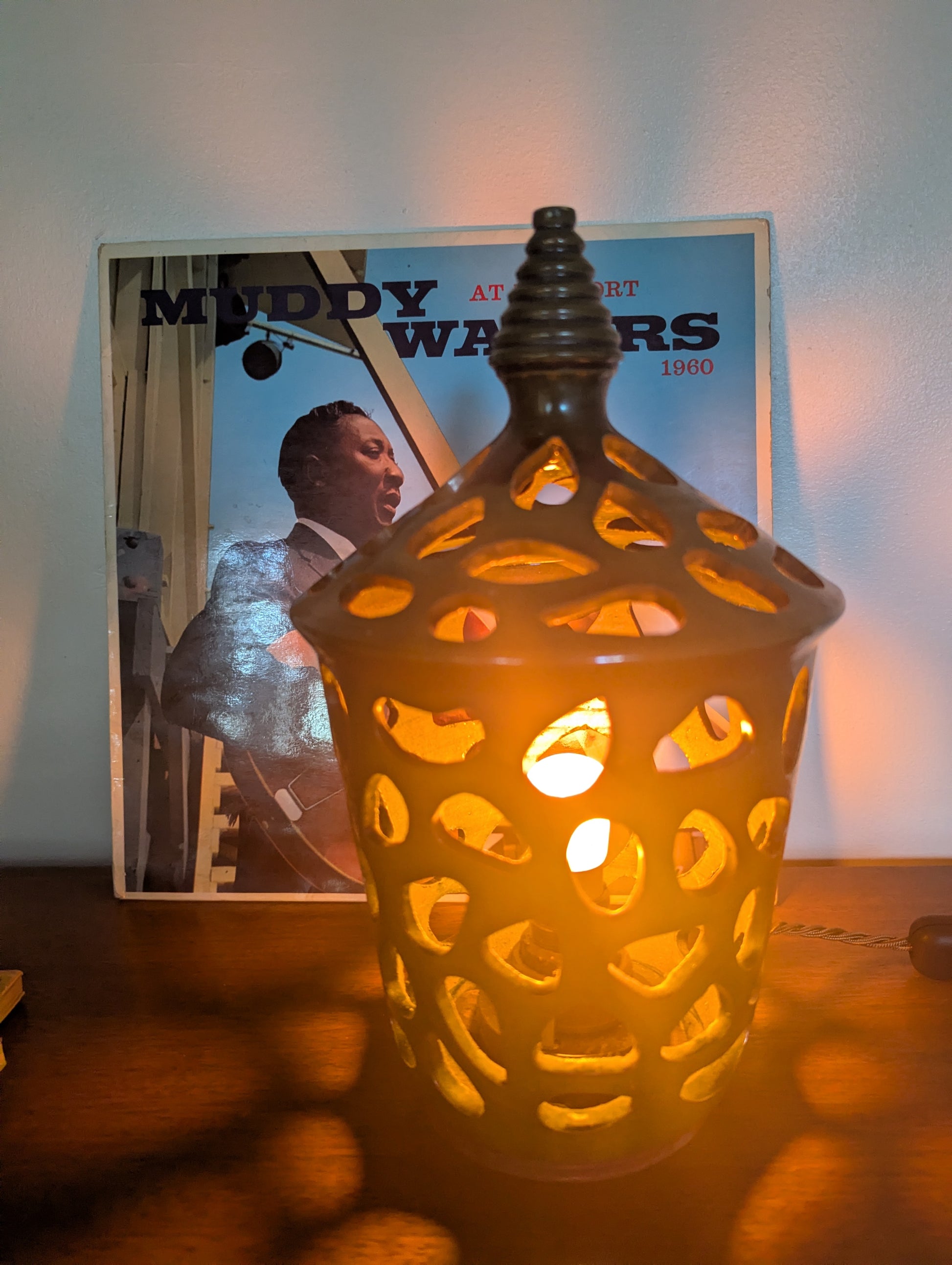 A ceramic mid twentieth century pottery table lamp on a wooden table top