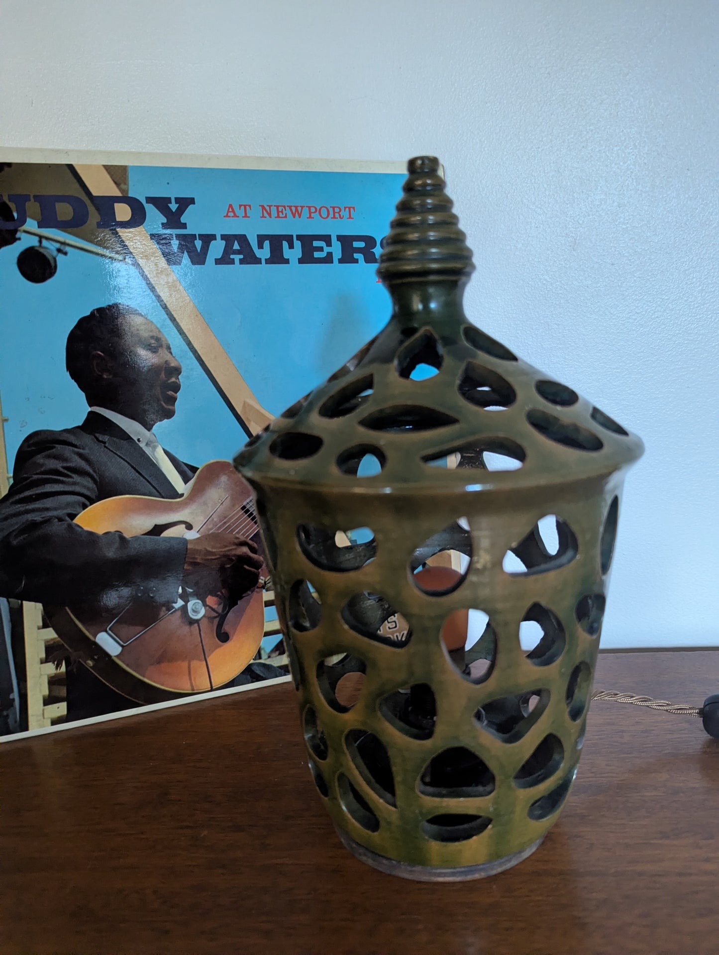A ceramic mid twentieth century pottery table lamp on a wooden table top
