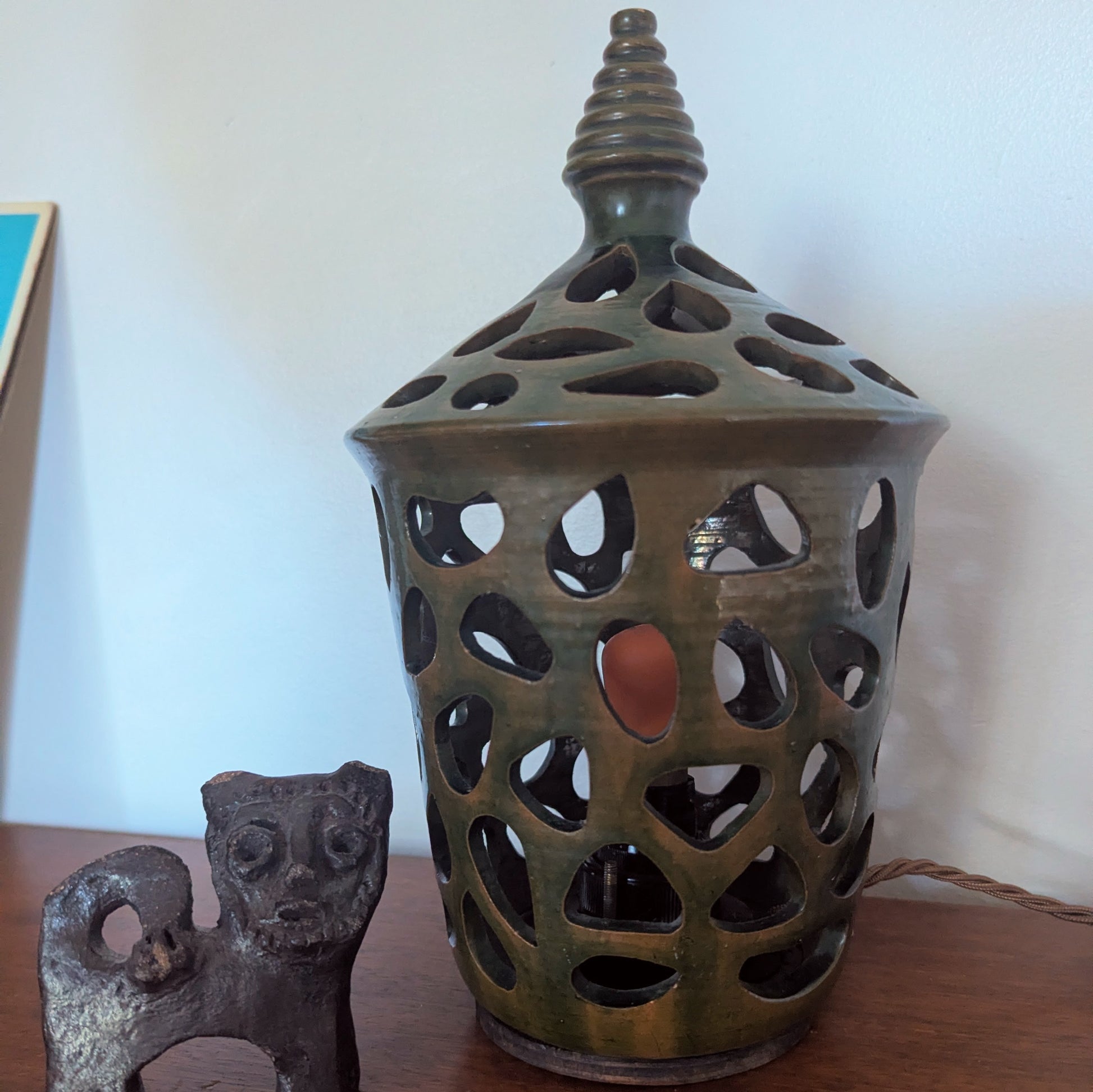 A ceramic mid twentieth century pottery table lamp on a wooden table top