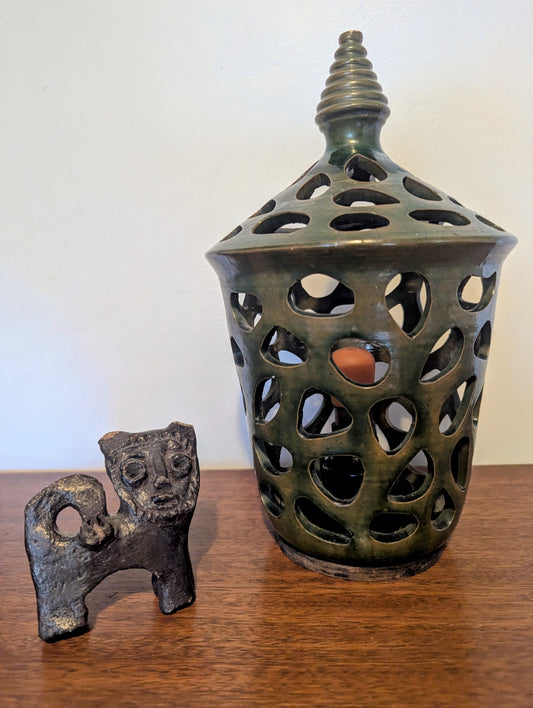 A ceramic mid twentieth century pottery table lamp on a wooden table top
