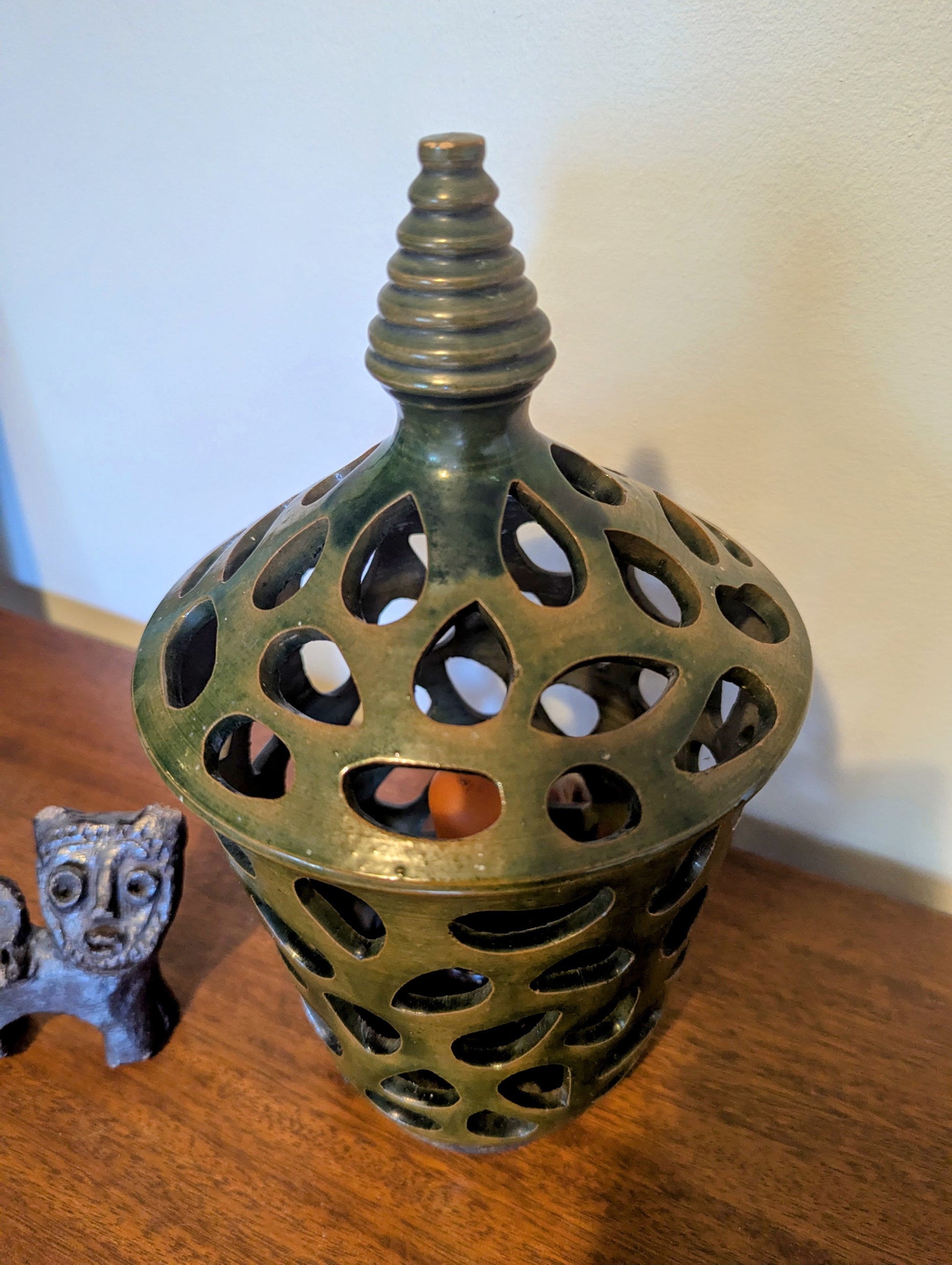 A ceramic mid twentieth century pottery table lamp on a wooden table top