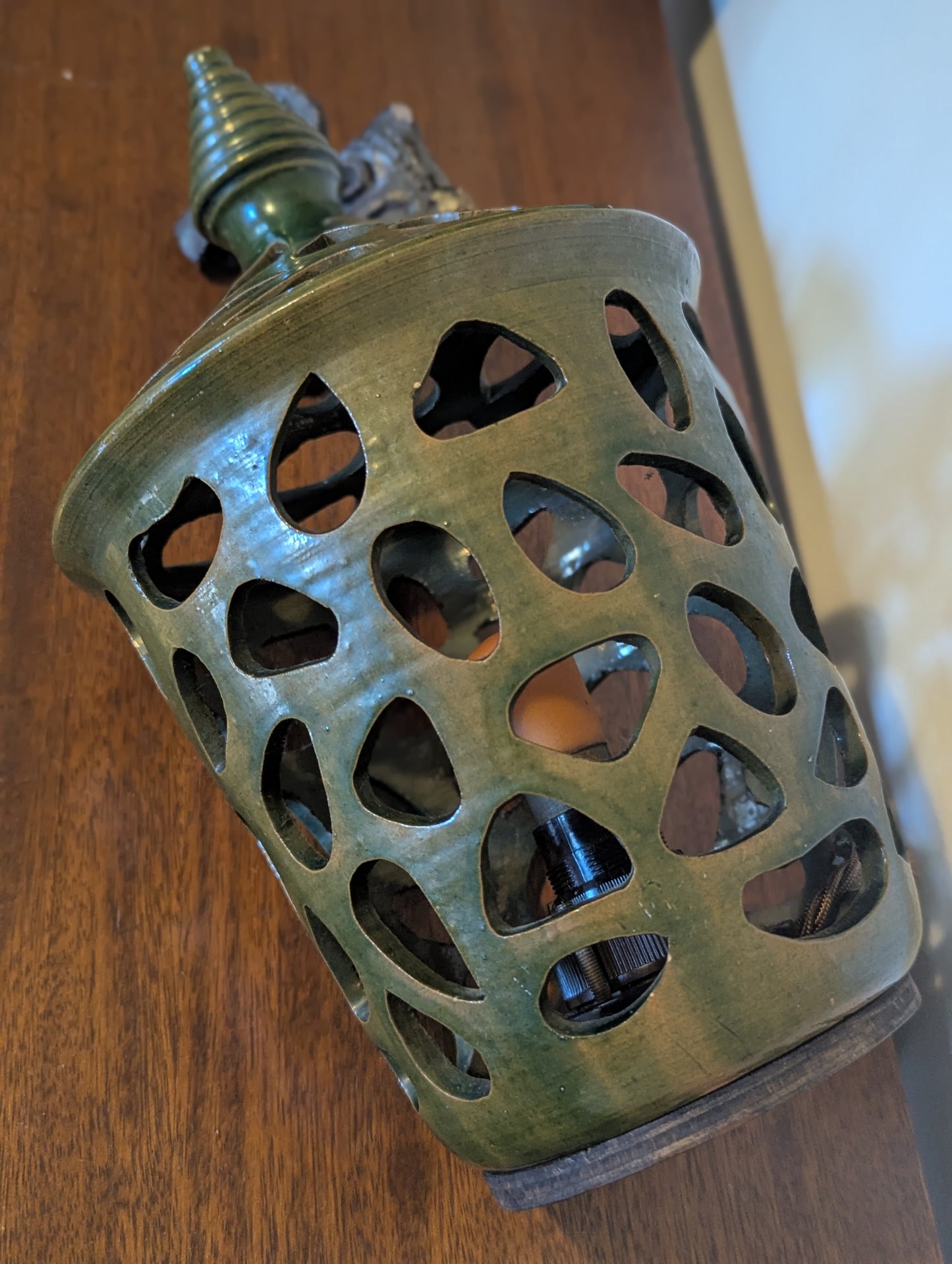 A ceramic mid twentieth century pottery table lamp on a wooden table top
