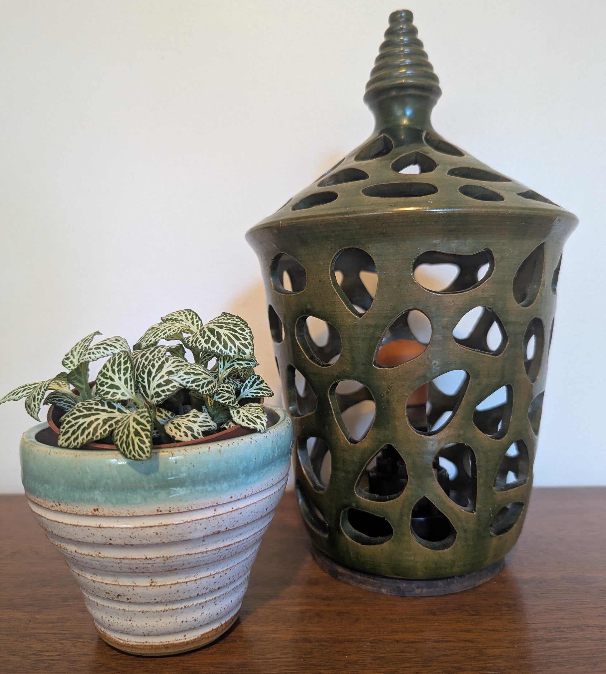 A ceramic mid twentieth century pottery table lamp on a wooden table top