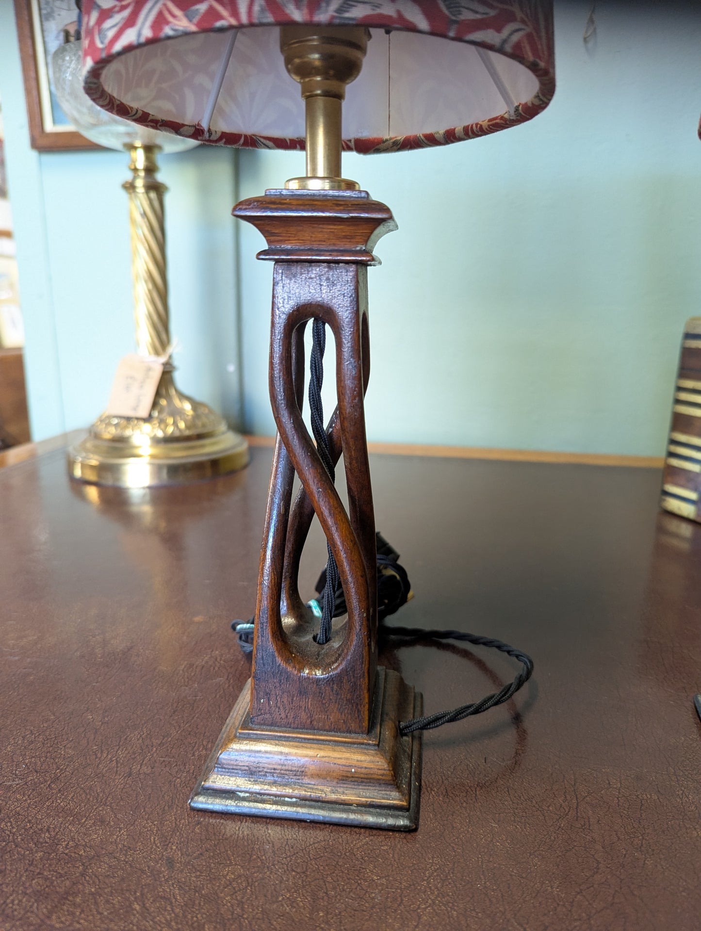Wooden arts & crafts movement table lamp with decorative base on a wooden surface